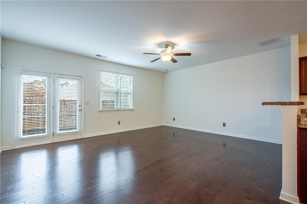 3207 Cyrus Point Lane Kennesaw, GA 30152 - Photo 9 of 24 a view of an empty room with a window and wooden floor