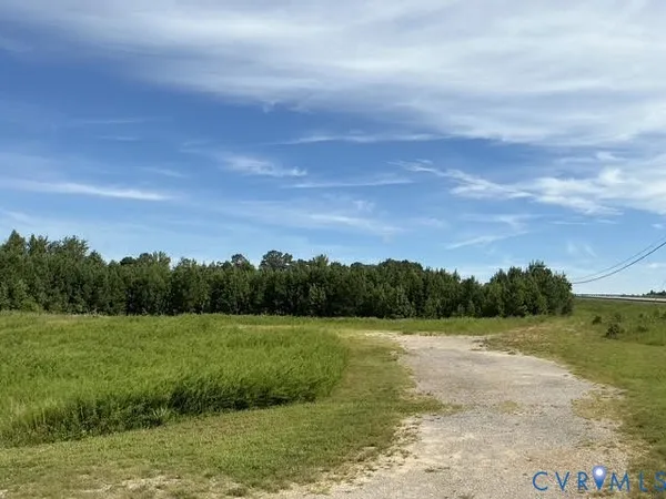 a view of a field with ocean view