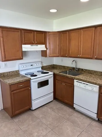 a view of a kitchen with a sink and a refrigerator