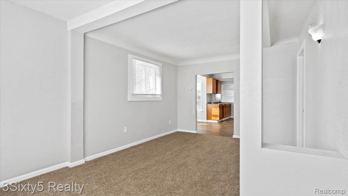 202 Haltiner Street River Rouge, MI 48218 - Photo 4 of 19 Unfurnished room with baseboards and dark carpet