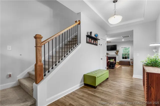 a view of an empty room with a fireplace and a window