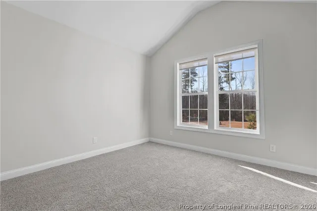 an aerial view of a house with a yard and trees