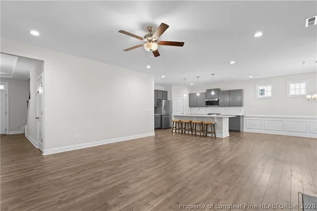 a kitchen with stainless steel appliances granite countertop a sink a stove and a refrigerator