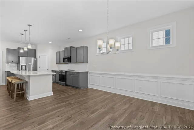 a kitchen with a sink a counter space cabinets and stainless steel appliances