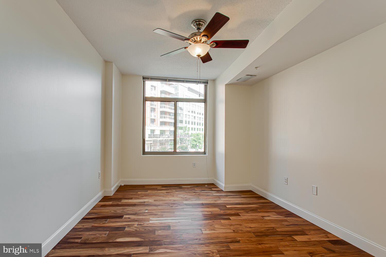 3650 South Glebe Road, Unit 239 Arlington, VA 22202 - Photo 12 of 38 an empty room with wooden floor and ceiling fan