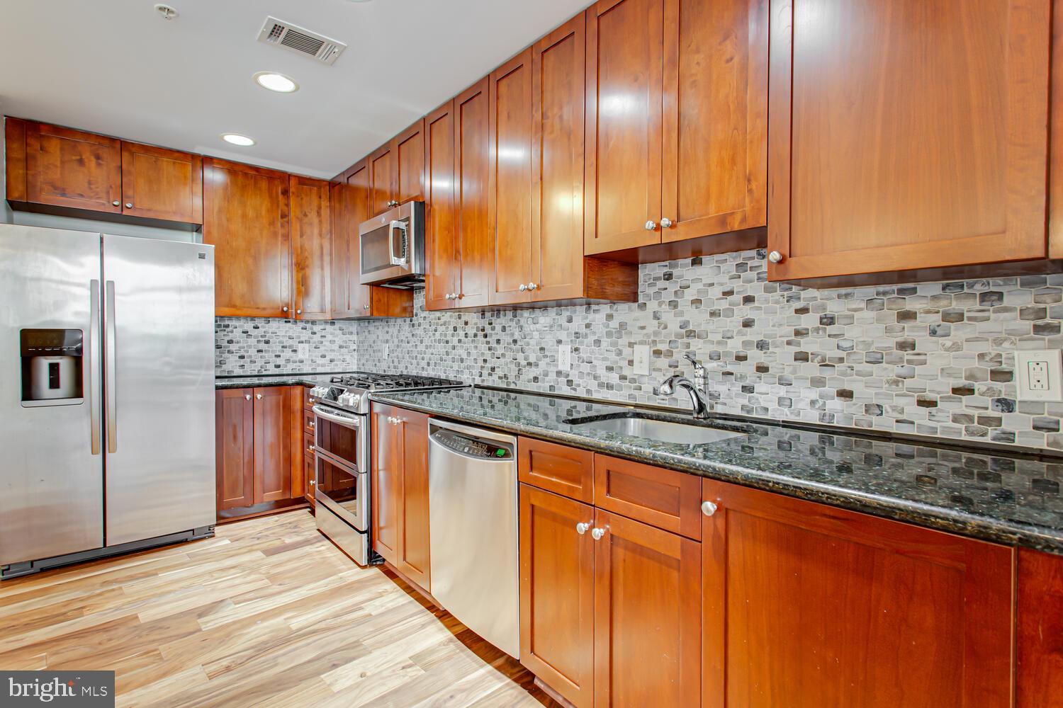 3650 South Glebe Road, Unit 239 Arlington, VA 22202 - Photo 3 of 38 a kitchen with stainless steel appliances granite countertop wooden cabinets a oven and granite counter tops