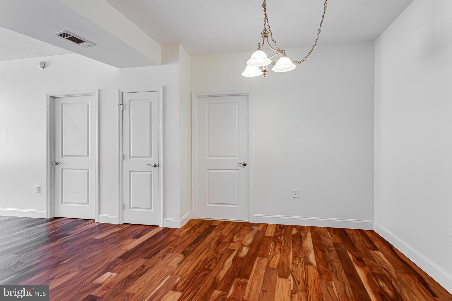 3650 South Glebe Road, Unit 239 Arlington, VA 22202 - Photo 8 of 38 a view of a room with wooden floor and flat screen tv