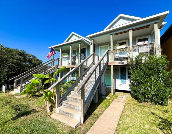 a front view of house along with deck and outdoor seating