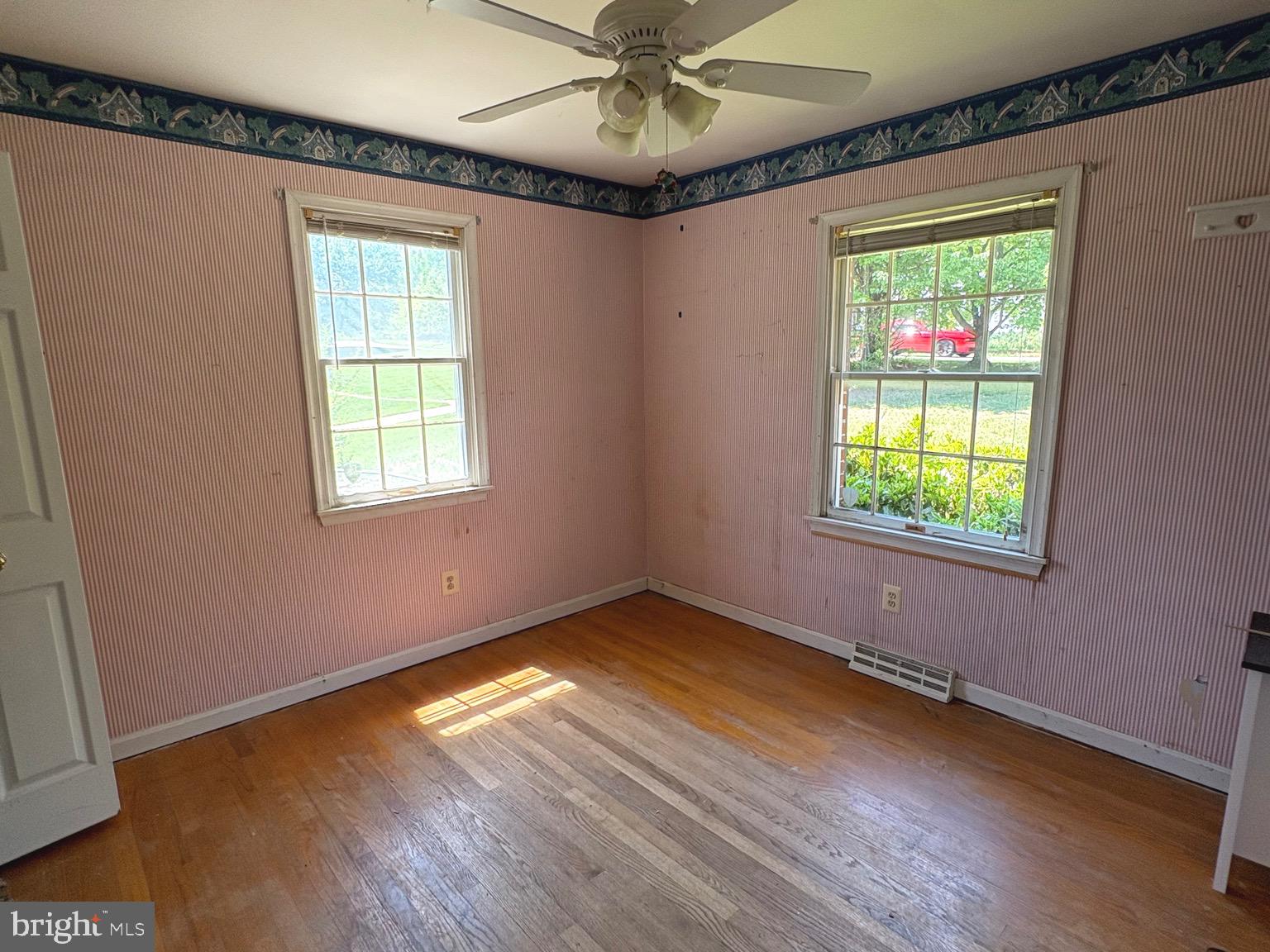 4215 Buffalo Road Mount Airy, MD 21771 - Photo 14 of 44 a view of an empty room with a window and wooden floor