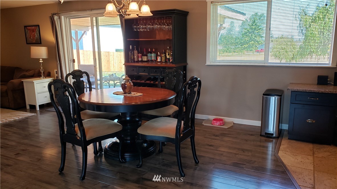 211 O Brien Road Port Angeles, WA 98362 - Photo 22 of 40 a view of a a dining room with furniture window and wooden floor