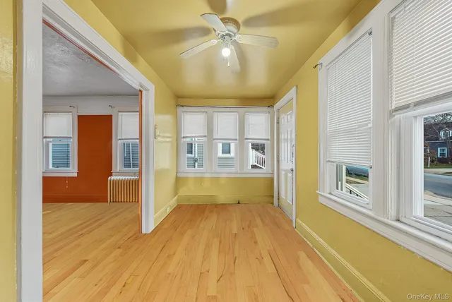 a view of an entryway with wooden floor