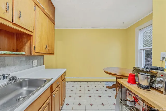 a kitchen with a sink a stove and cabinets