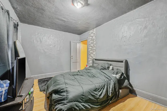 a bed sitting in a bedroom next to a window