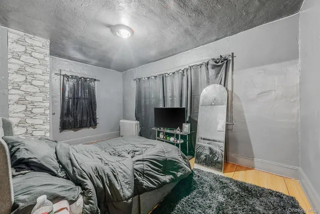 a bedroom with a bed couch and a mirror