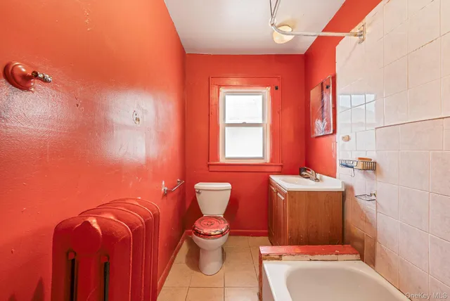 a bathroom with a toilet a sink and bathtub