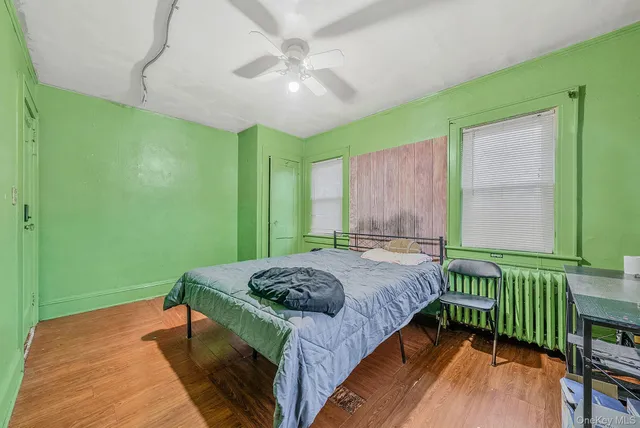 a bedroom with a bed and a window