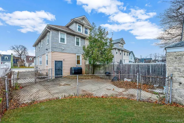 a view of a house with a patio and a yard