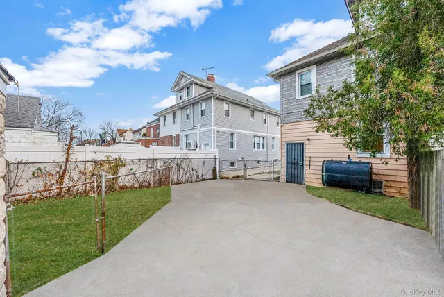 a view of a house with a big yard and a large tree