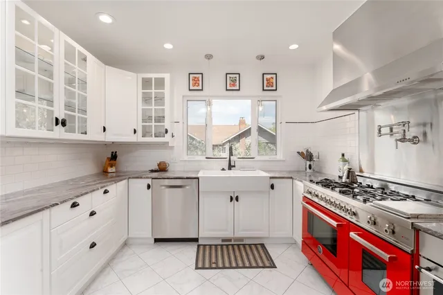 a kitchen with stainless steel appliances a sink stove and cabinets