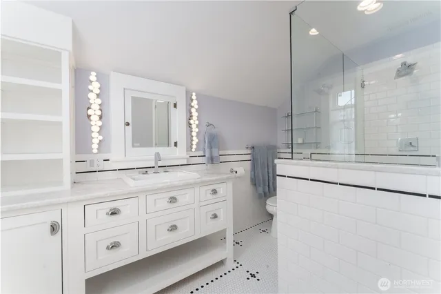 a bathroom with a granite countertop double vanity sink mirror and