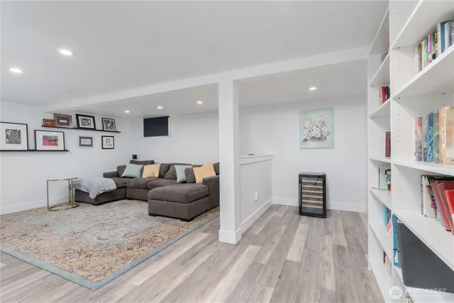 a living room with furniture and a book shelf