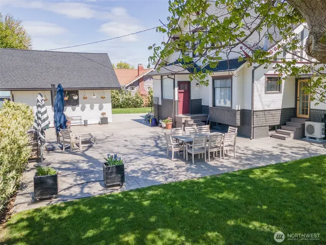 a view of a patio with table and chairs and potted plants