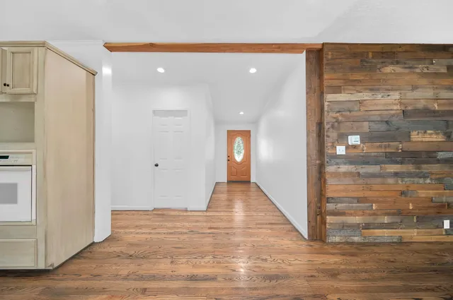 a view of a hallway with wooden floor