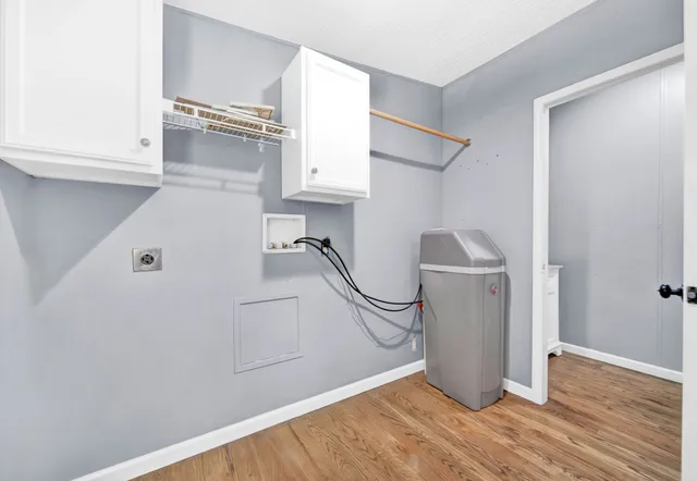 a utility room with cabinets dryer and washer