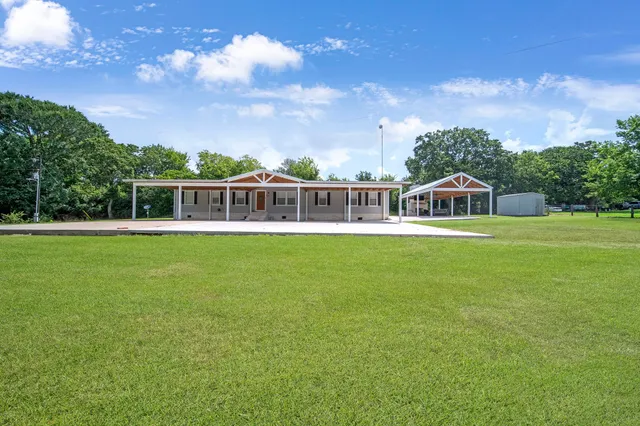 a view of a house with a big yard