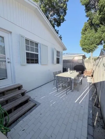 a view of balcony with a potted plant and outdoor seating