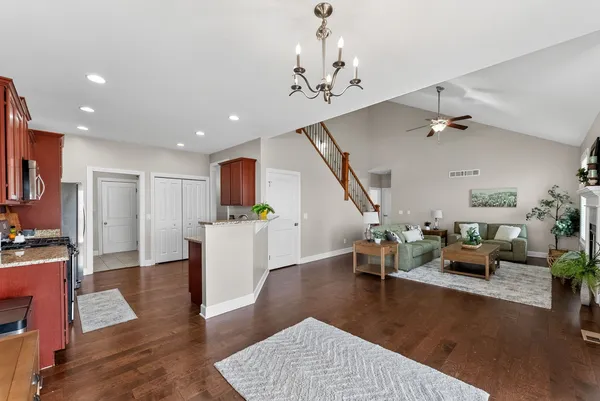 a living room with furniture and a chandelier