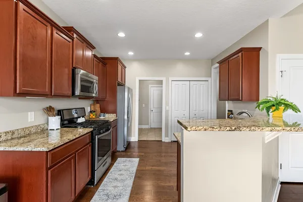 a kitchen with stainless steel appliances granite countertop a sink stove and refrigerator
