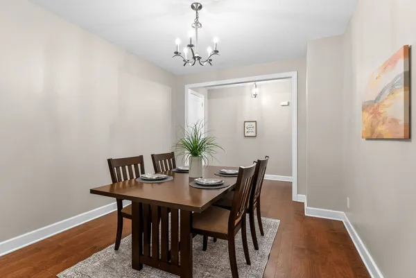 a view of a dining room with furniture and chandelier
