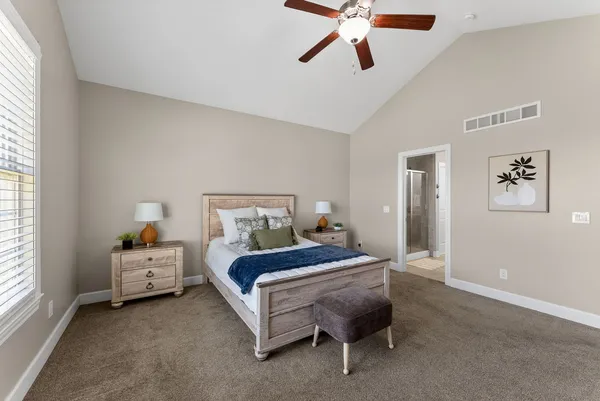 a bedroom with a bed and a chandelier