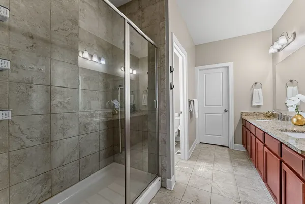 a bathroom with a shower and a sink