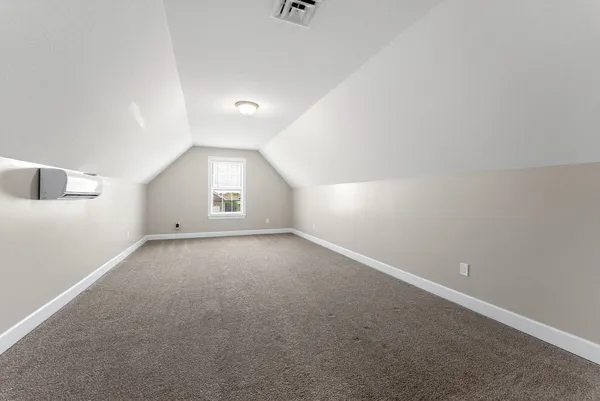 an empty room with a window and closet