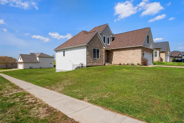 a front view of house with yard and green space
