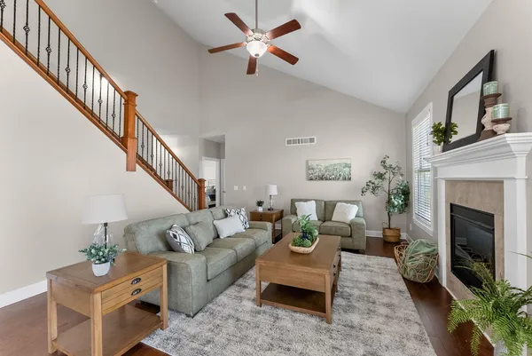 a living room with furniture a fireplace and a flat screen tv