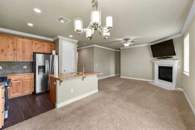 a bathroom with a granite countertop tub sink and mirror