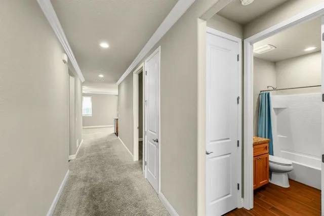 an empty room with windows and wooden floor
