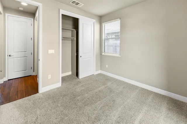 a view of an empty room with a fireplace and a flat screen tv