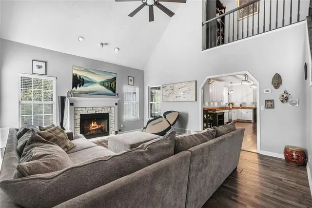 a kitchen with stainless steel appliances kitchen island granite countertop a table chairs sink and cabinets