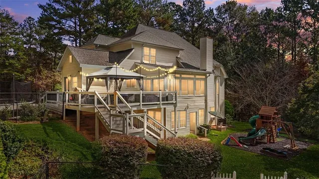 a view of a chair and table in backyard of the house