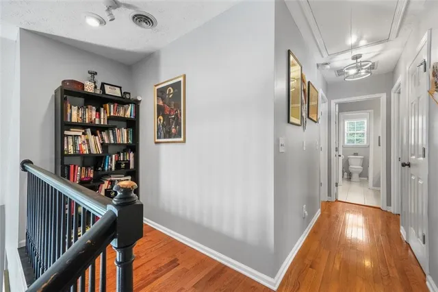 a bathroom with a granite countertop sink mirror and toilet