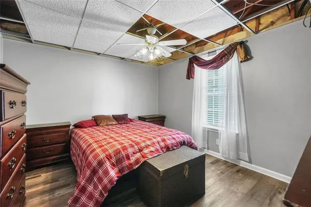 a front view of a house with a yard and potted plants