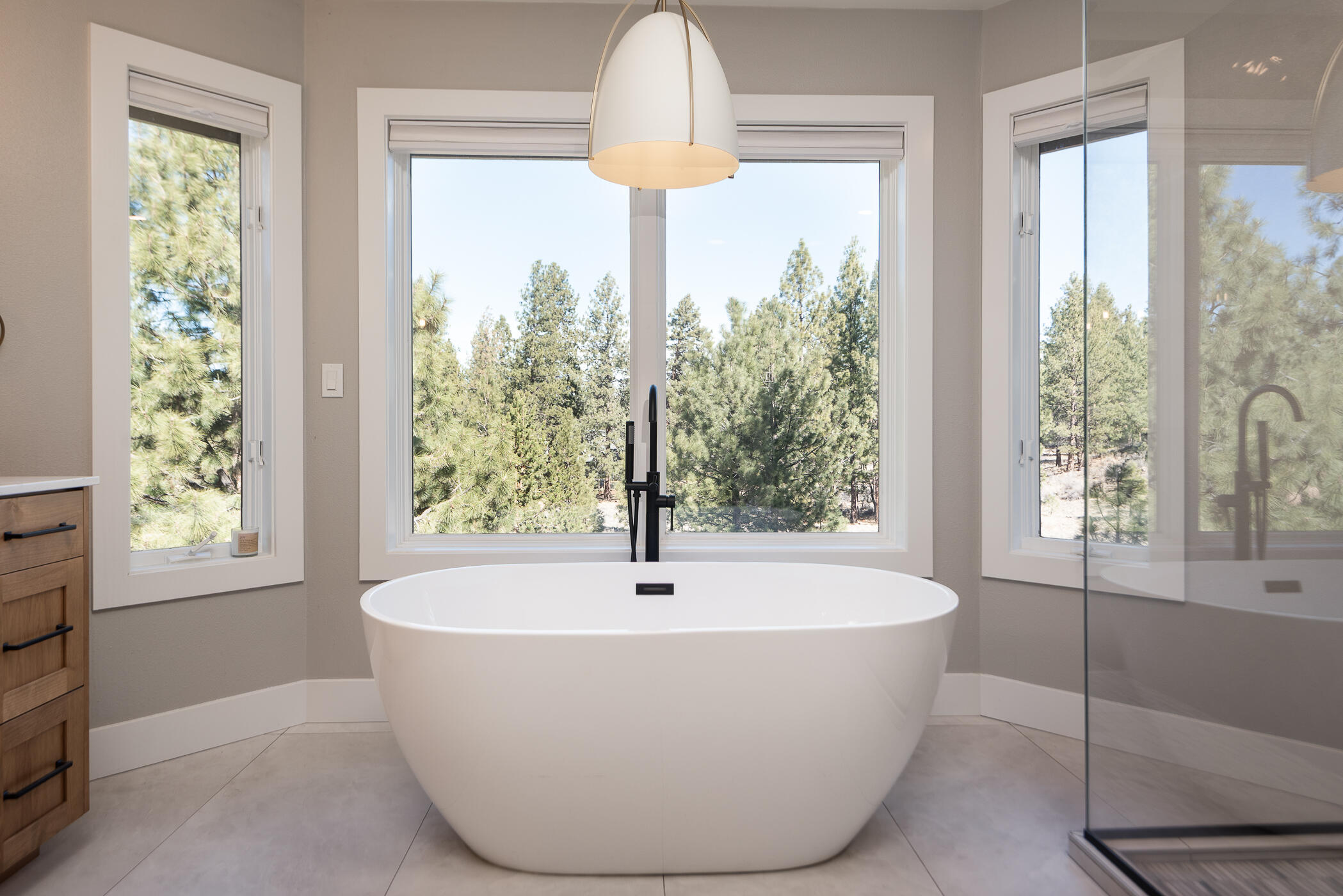 60012 West Ridgeview Drive Bend, OR 97702 - Photo 17 of 55 a white bath tub sitting in a bathroom next to a window