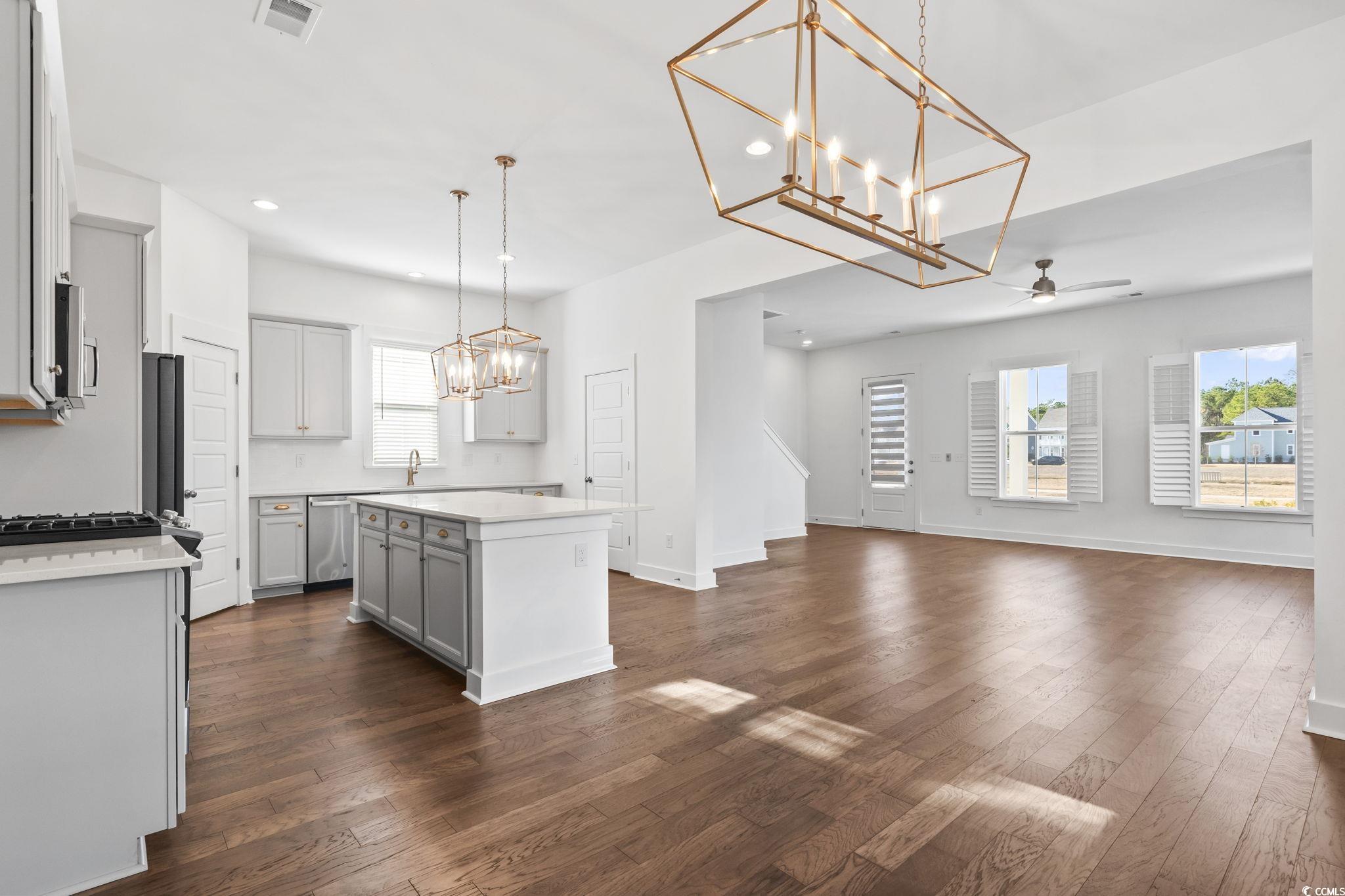1524 Sayebrook Parkway Myrtle Beach, SC 29588 - Photo 16 of 40 Kitchen featuring a chandelier, hanging light fixtures, gray cabinets, a kitchen island, and dark wood finished floors