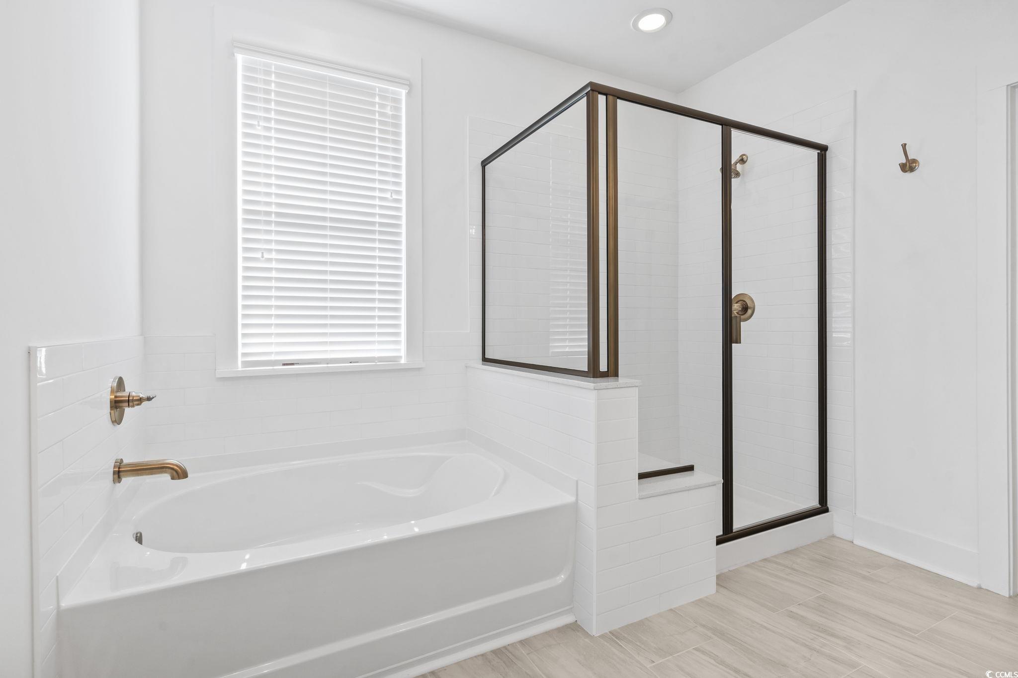 1524 Sayebrook Parkway Myrtle Beach, SC 29588 - Photo 23 of 40 Full bathroom with a garden tub, a stall shower, wood finish floors, and recessed lighting