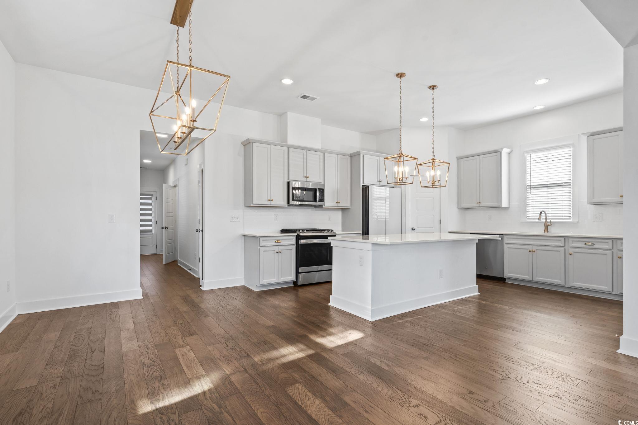 1524 Sayebrook Parkway Myrtle Beach, SC 29588 - Photo 9 of 40 Kitchen featuring a chandelier, hanging light fixtures, appliances with stainless steel finishes, a center island, and recessed lighting