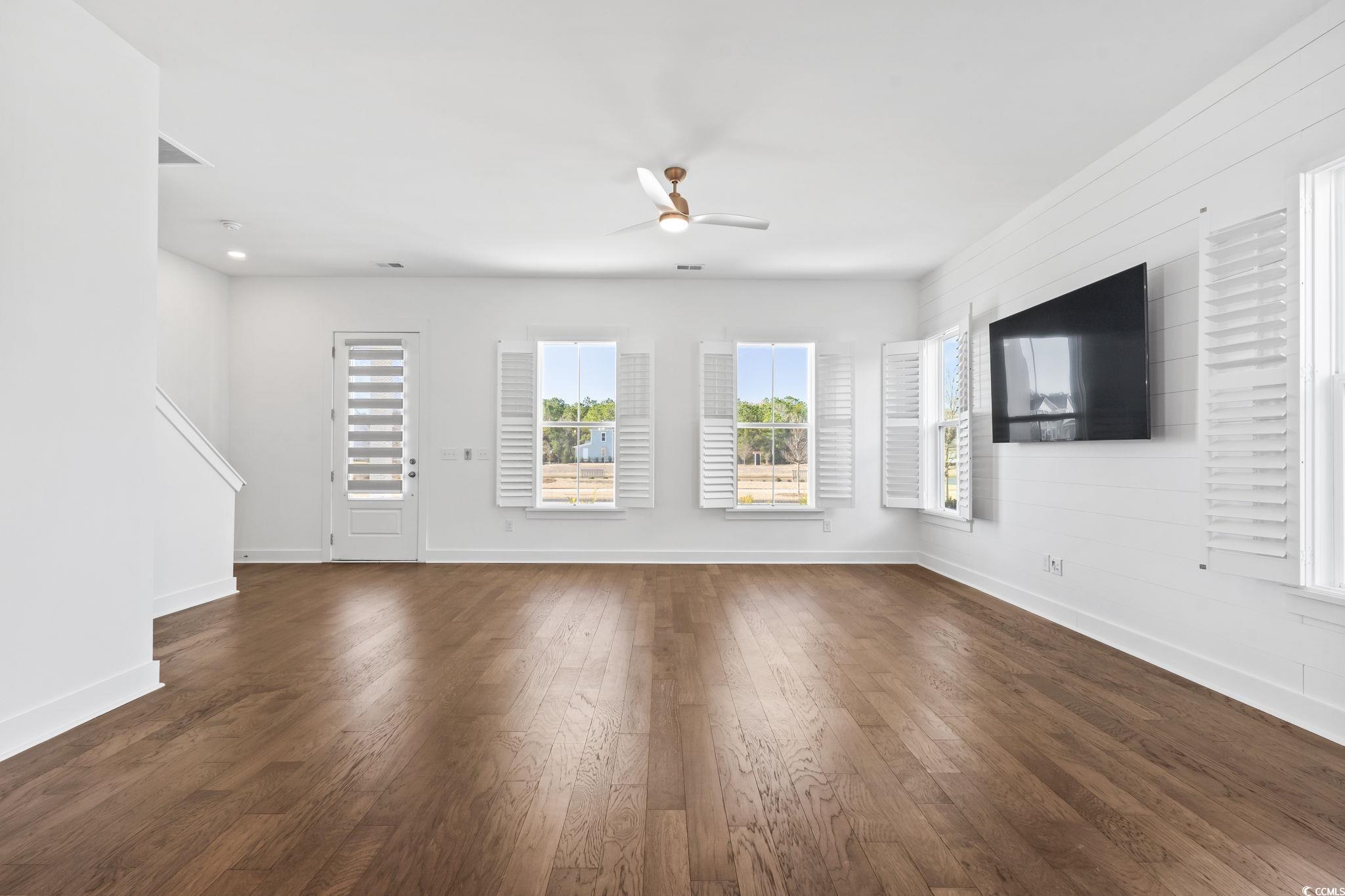 1524 Sayebrook Parkway Myrtle Beach, SC 29588 - Photo 10 of 40 Unfurnished living room featuring ceiling fan and dark wood-style flooring
